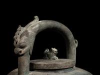 An Archaic Bronze Tripod Wine Vessel, He