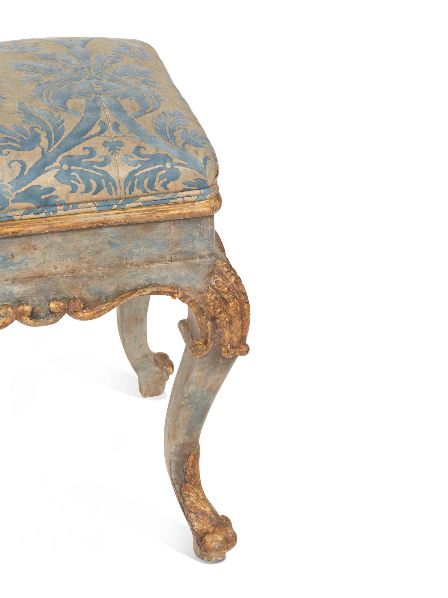 An Italian Painted and Parcel Gilt Bench with Fortuny Upholstery