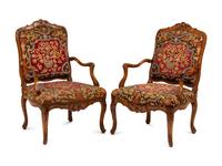 A Pair of Régence Walnut Needlepoint-Upholstered Fauteuils