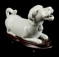 A Chinese Export Blanc de Chine Porcelain Figure of a Recumbent Dog — 19TH CENTURY