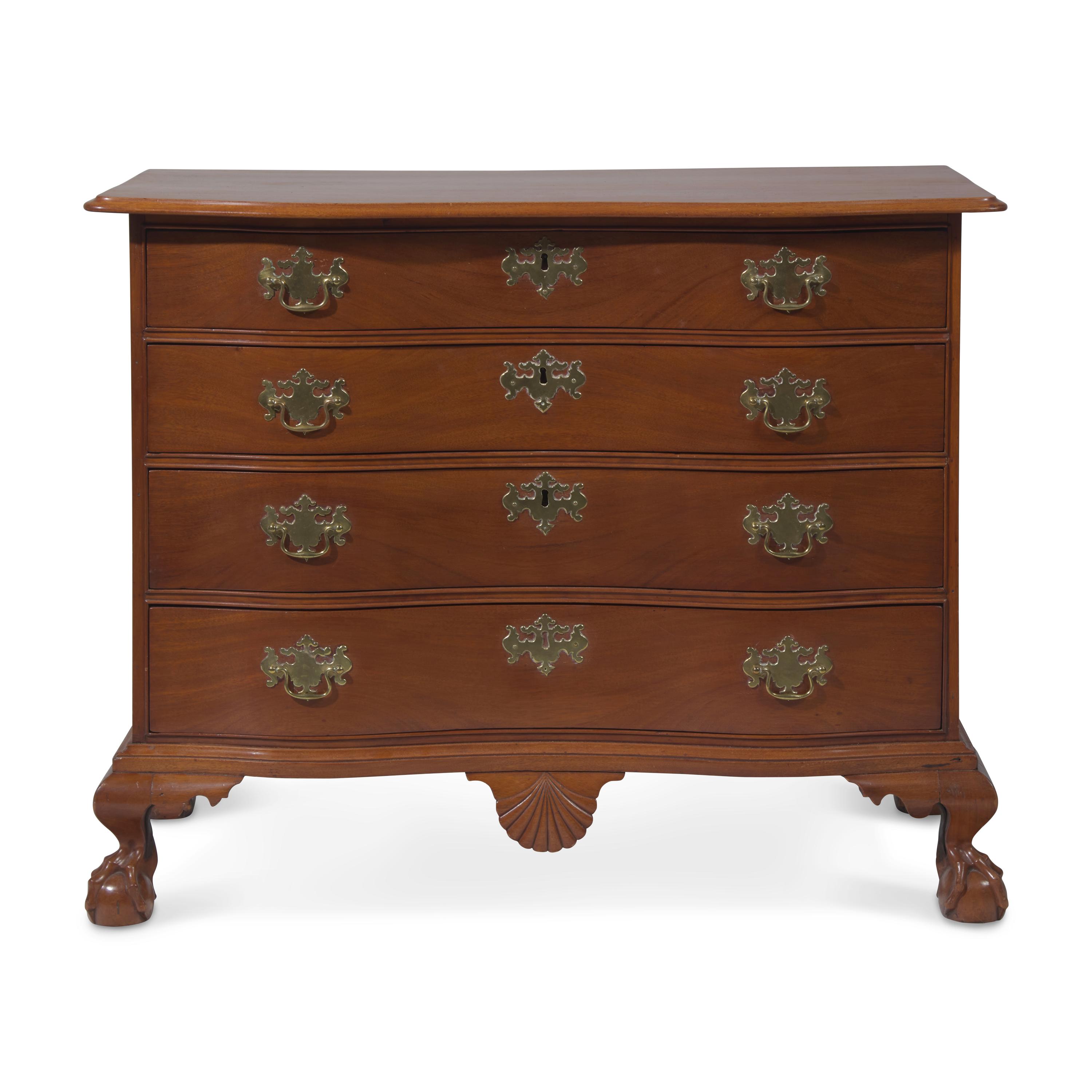 A Chippendale Figured and Shell-Carved Mahogany Reverse-Serpentine Chest of Drawers