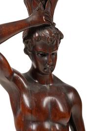 A Continental Carved Mahogany Figural Pedestal