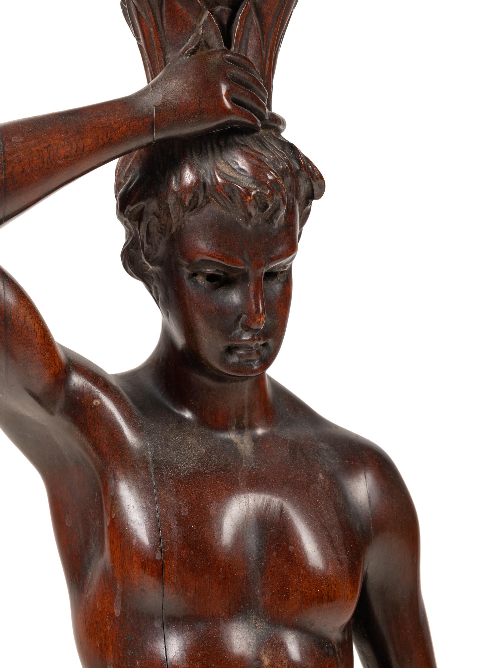 A Continental Carved Mahogany Figural Pedestal