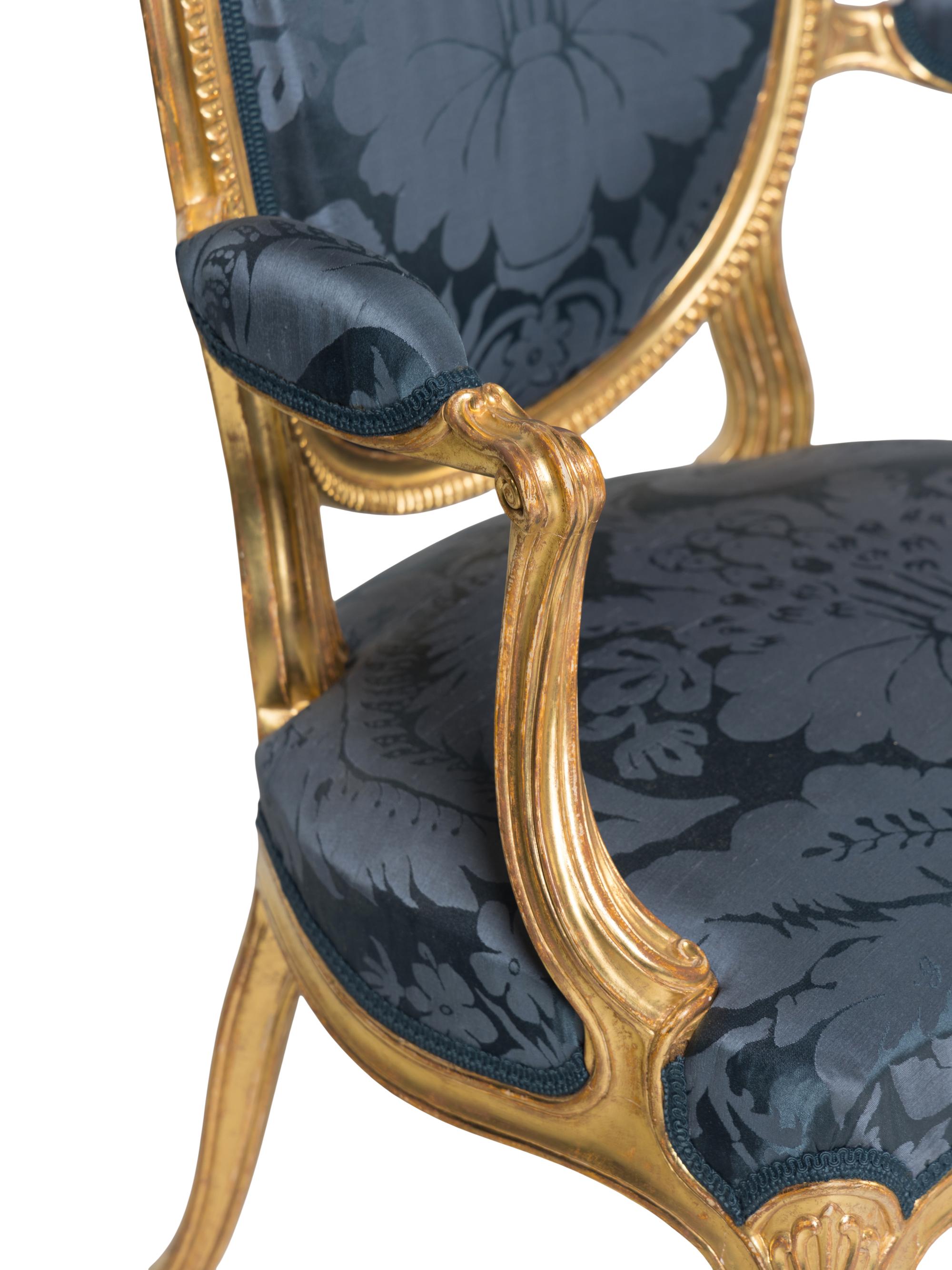 A Set of Six George III Carved Giltwood Armchairs
