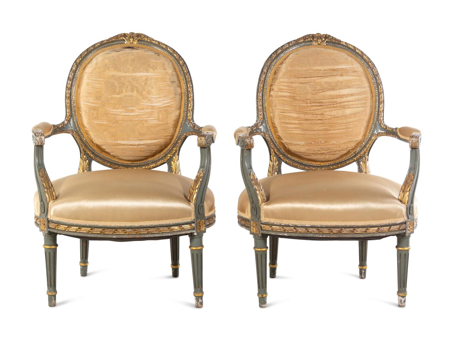 A Pair of Louis XVI Style Painted and Parcel Gilt Fauteuils