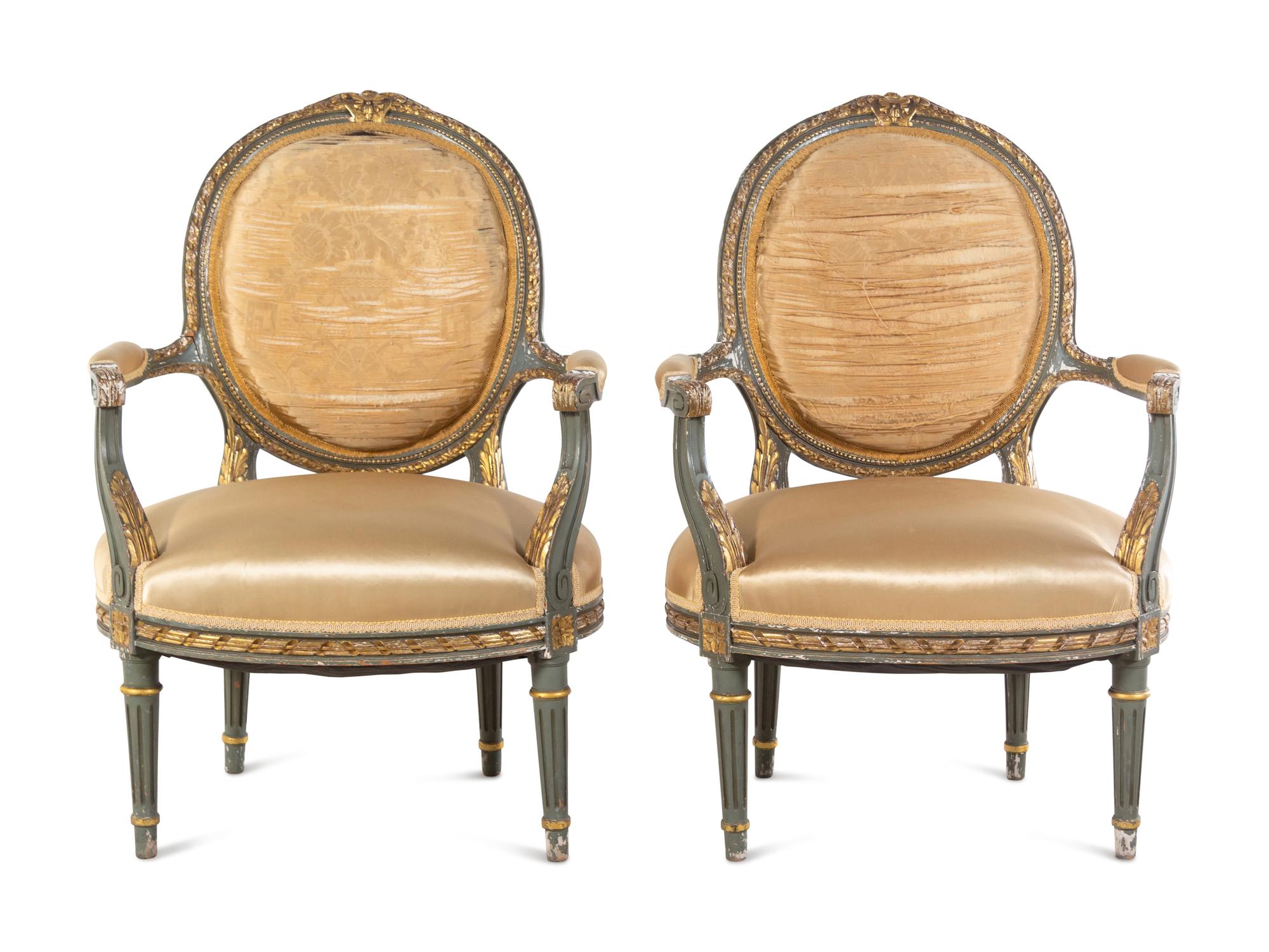 A Pair of Louis XVI Style Painted and Parcel Gilt Fauteuils