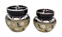 Two H.C. Edmiston Ceramic Silver Overlay Tobacco Jars Height of taller 5 1/2 inches.