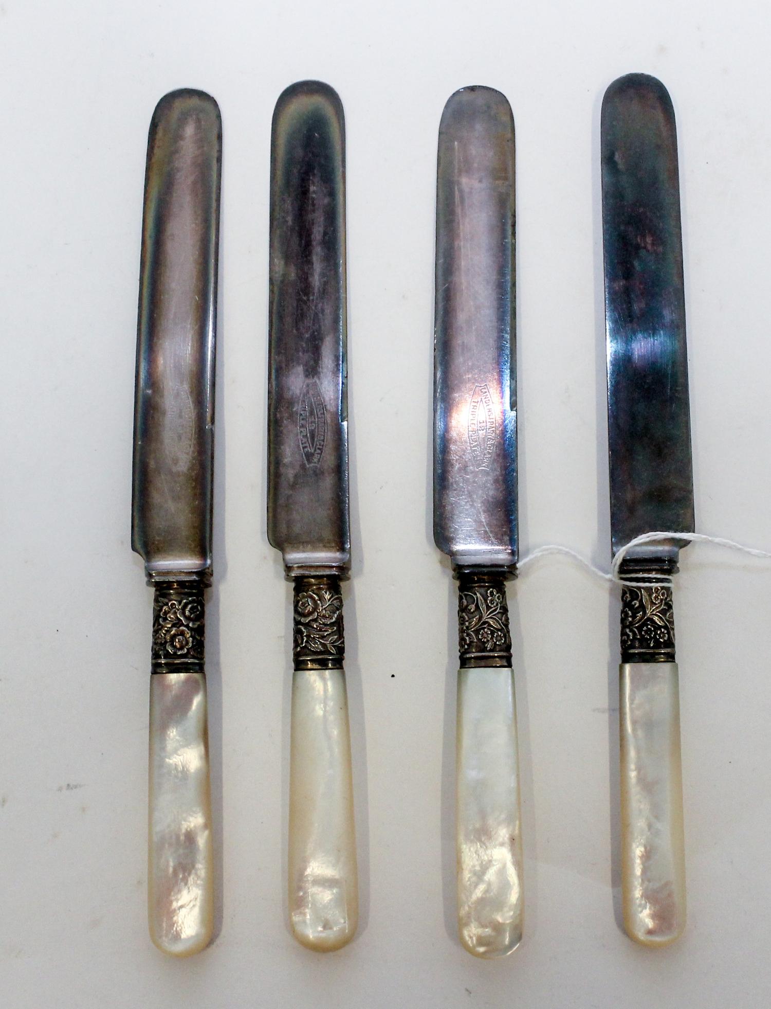 A Set of Twelve Silver-Plate and Mother of Pearl Dinner Knives, , each with a mother of pearl handle, the ferrule decorated with floral