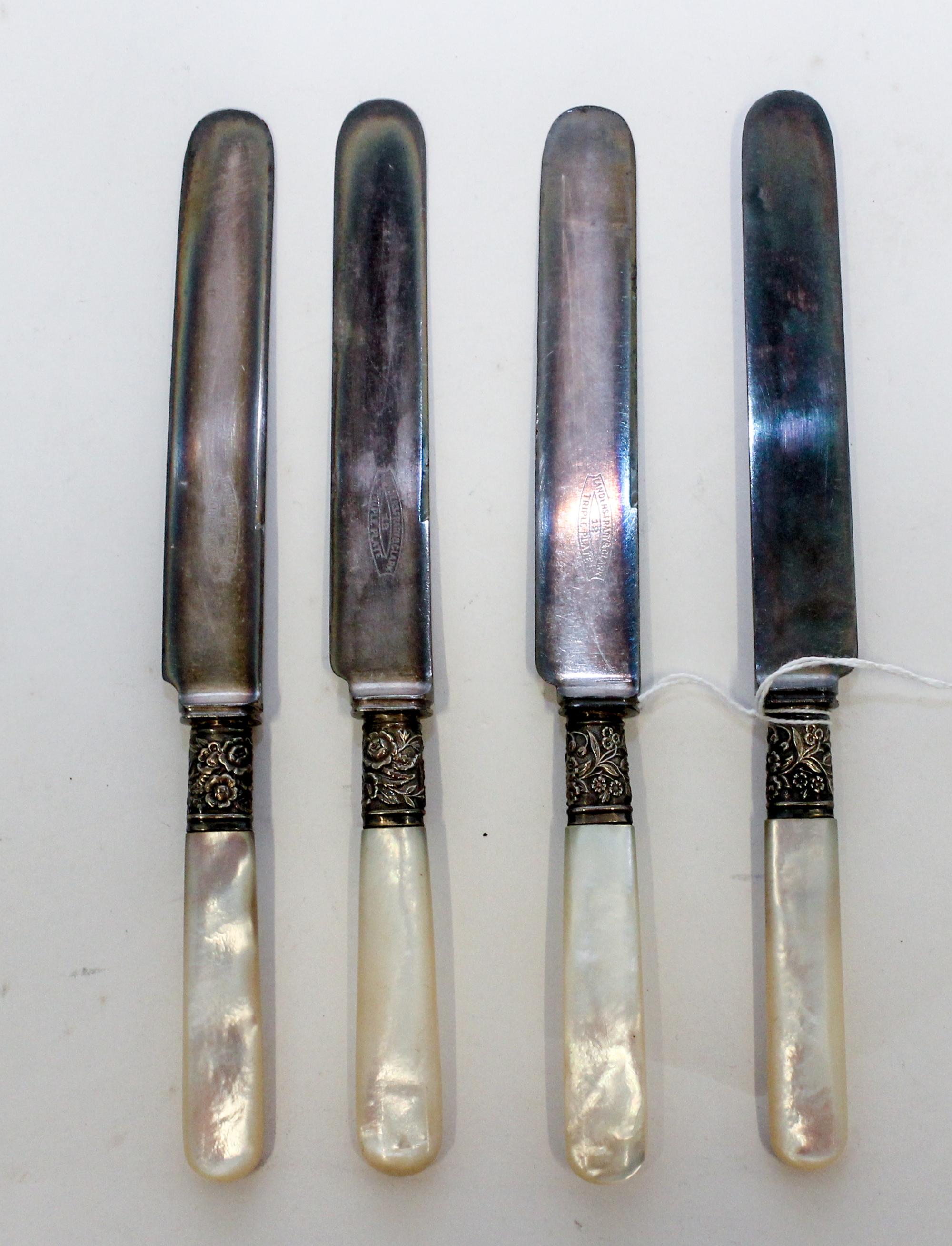 A Set of Twelve Silver-Plate and Mother of Pearl Dinner Knives, , each with a mother of pearl handle, the ferrule decorated with floral