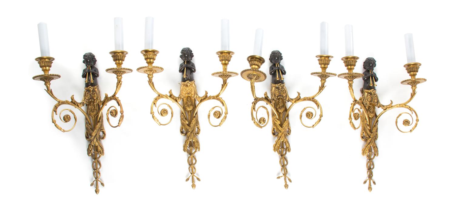 A Set of Four Neoclassical Patinated and Parcel Gilt Bronze Two-Light Figural Sconces, Height 16 3/4 inches.