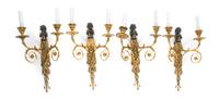 A Set of Four Neoclassical Patinated and Parcel Gilt Bronze Two-Light Figural Sconces, Height 16 3/4 inches.