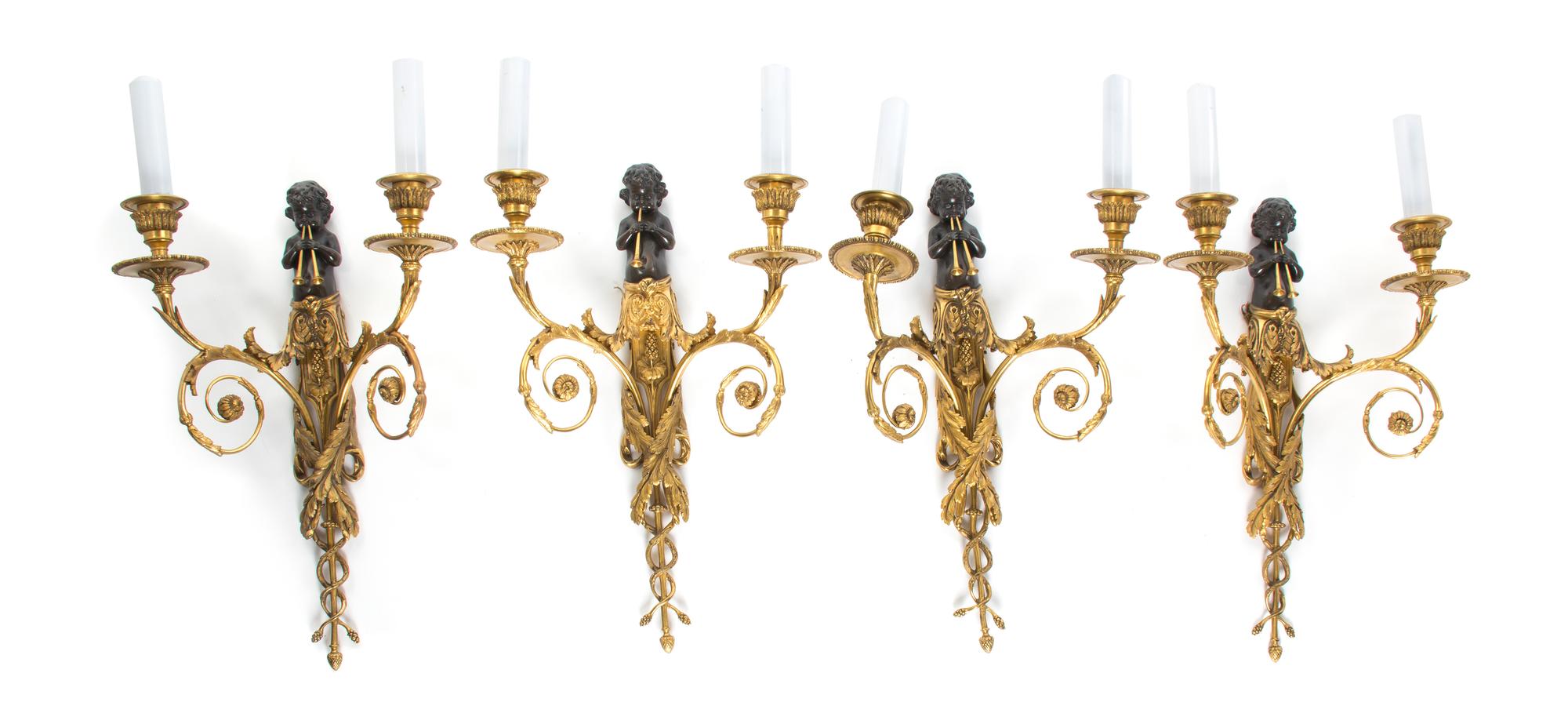 A Set of Four Neoclassical Patinated and Parcel Gilt Bronze Two-Light Figural Sconces, Height 16 3/4 inches.