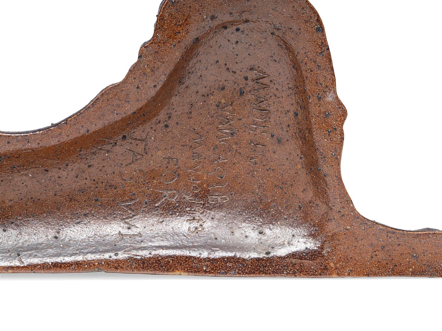 A Glazed Sewer Tile Recumbent Lion Doorstop