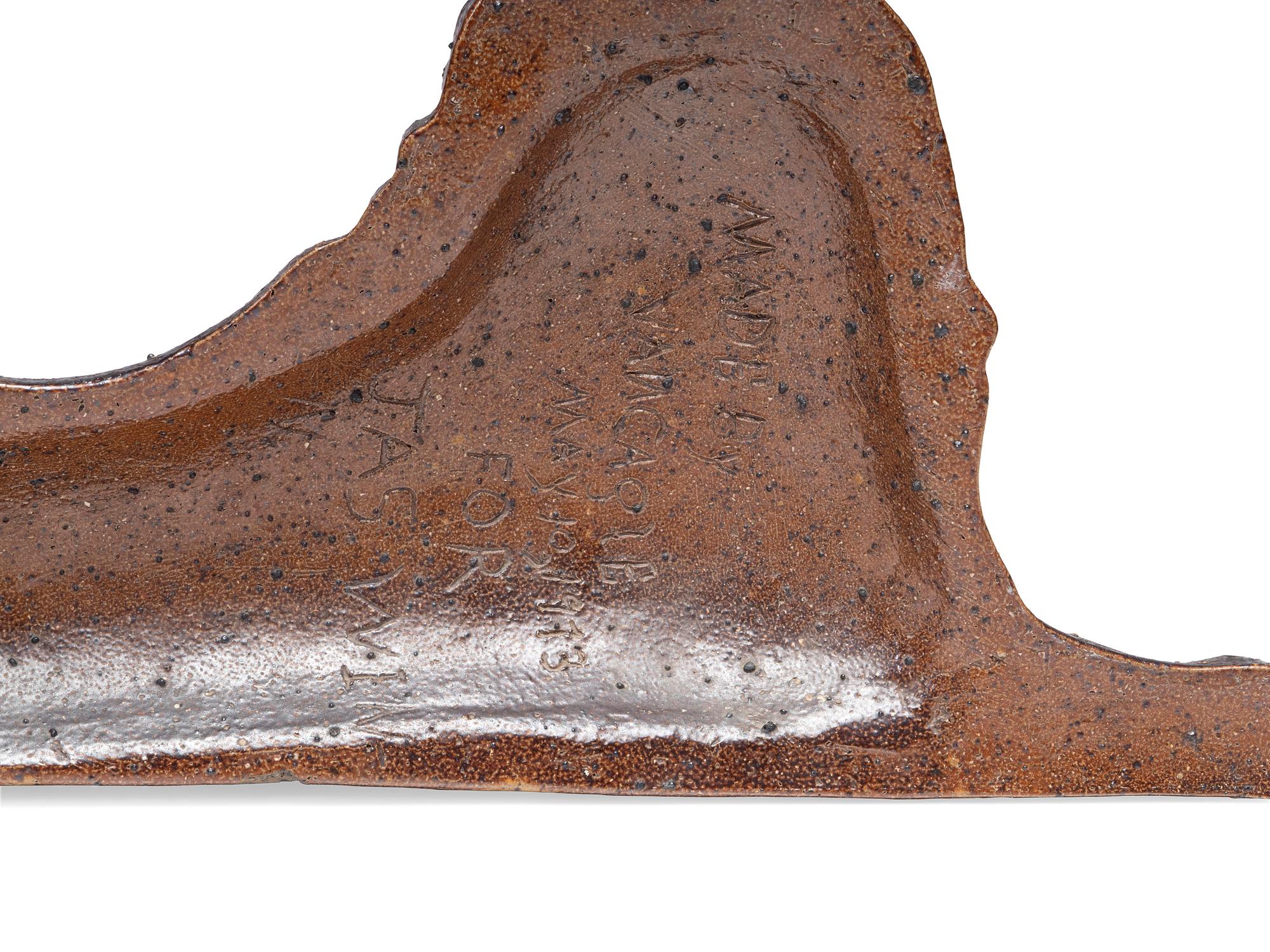 A Glazed Sewer Tile Recumbent Lion Doorstop