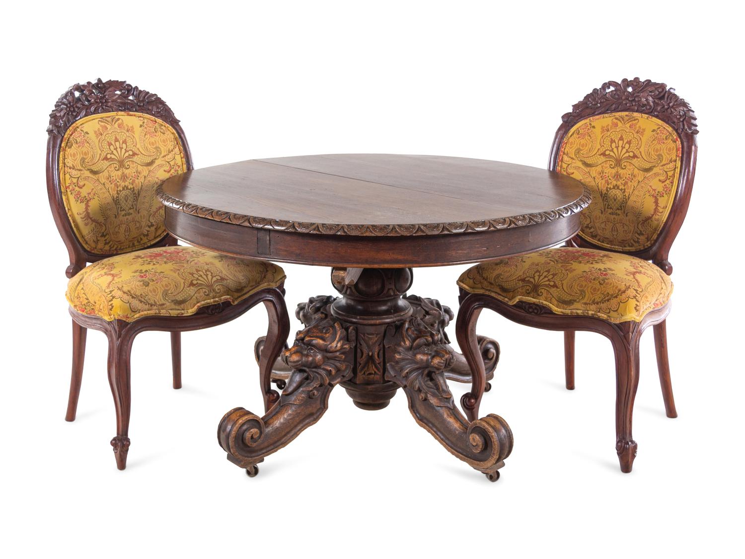 A Renaissance Revival Carved Walnut Breakfast Table and Chairs