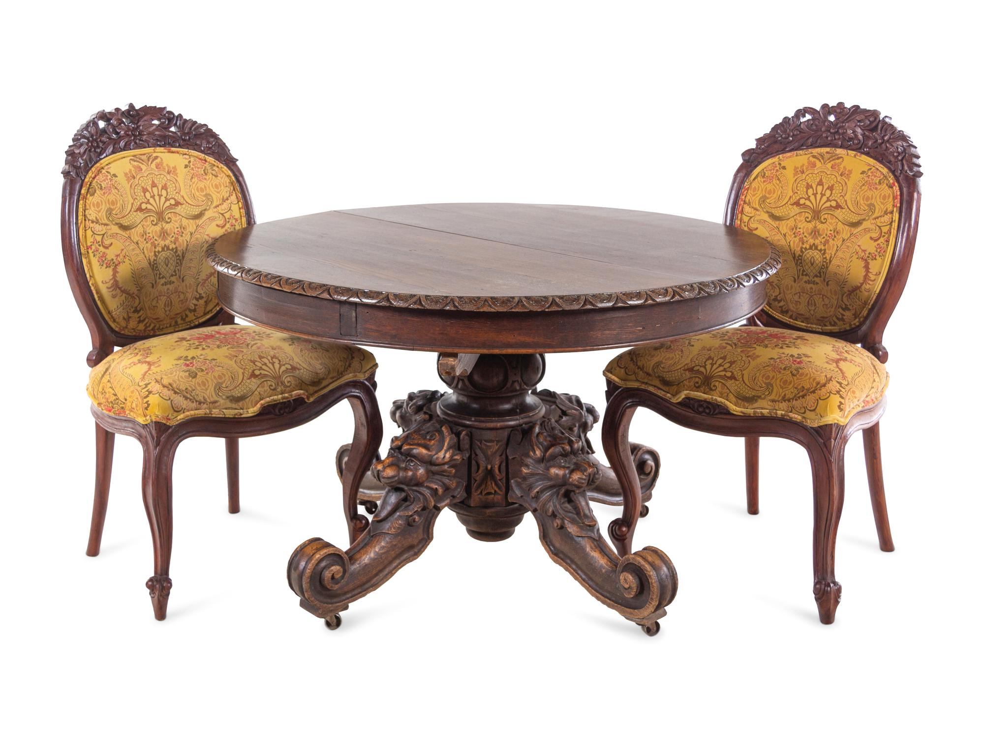 A Renaissance Revival Carved Walnut Breakfast Table and Chairs
