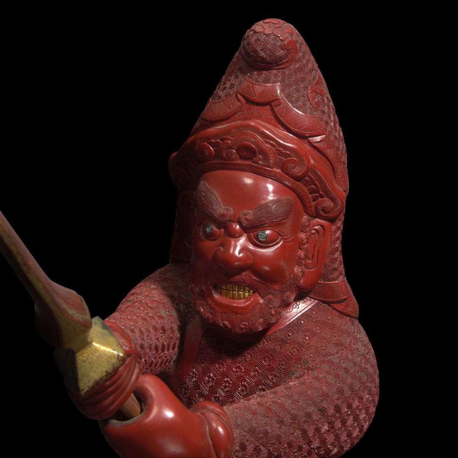 An unusual and finely-carved cinnabar lacquer figure of a warrior 朱漆武士像