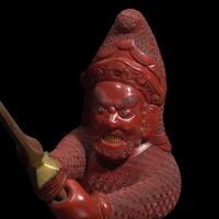 An unusual and finely-carved cinnabar lacquer figure of a warrior 朱漆武士像
