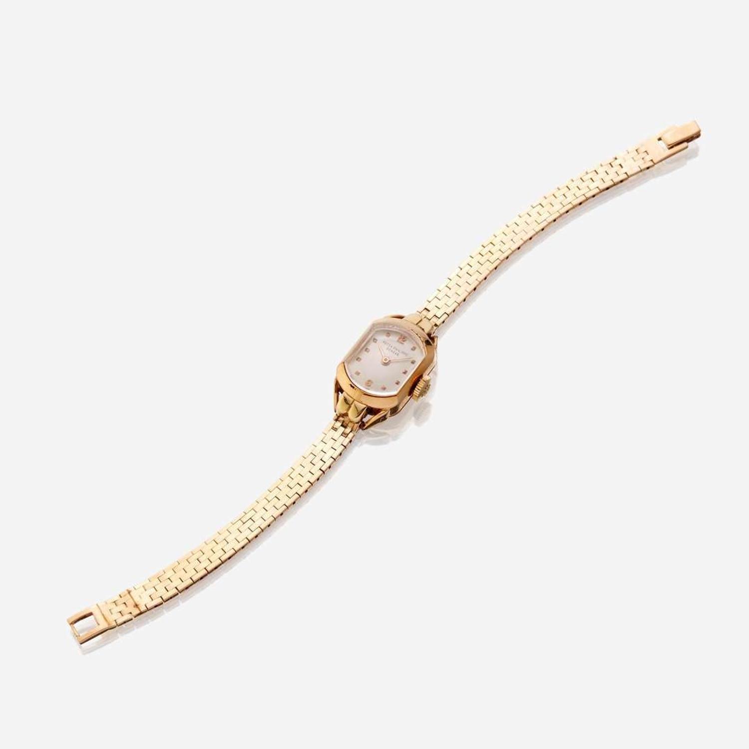 A lady's eighteen karat gold watch with later added fourteen karat gold bracelet, Patek Philippe circa 1940's