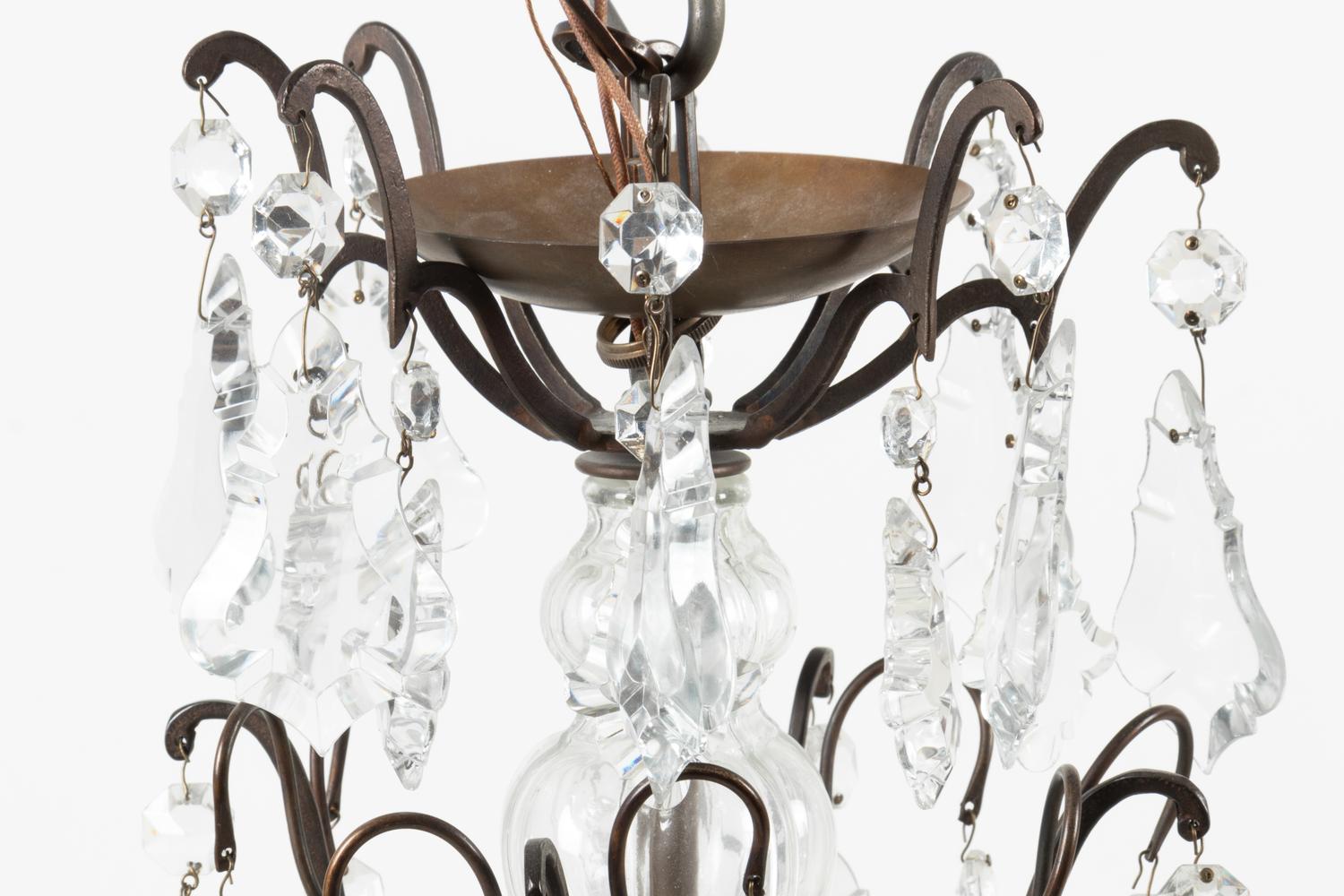 A French Patinated Metal and Cut Glass Eight-Light Chandelier