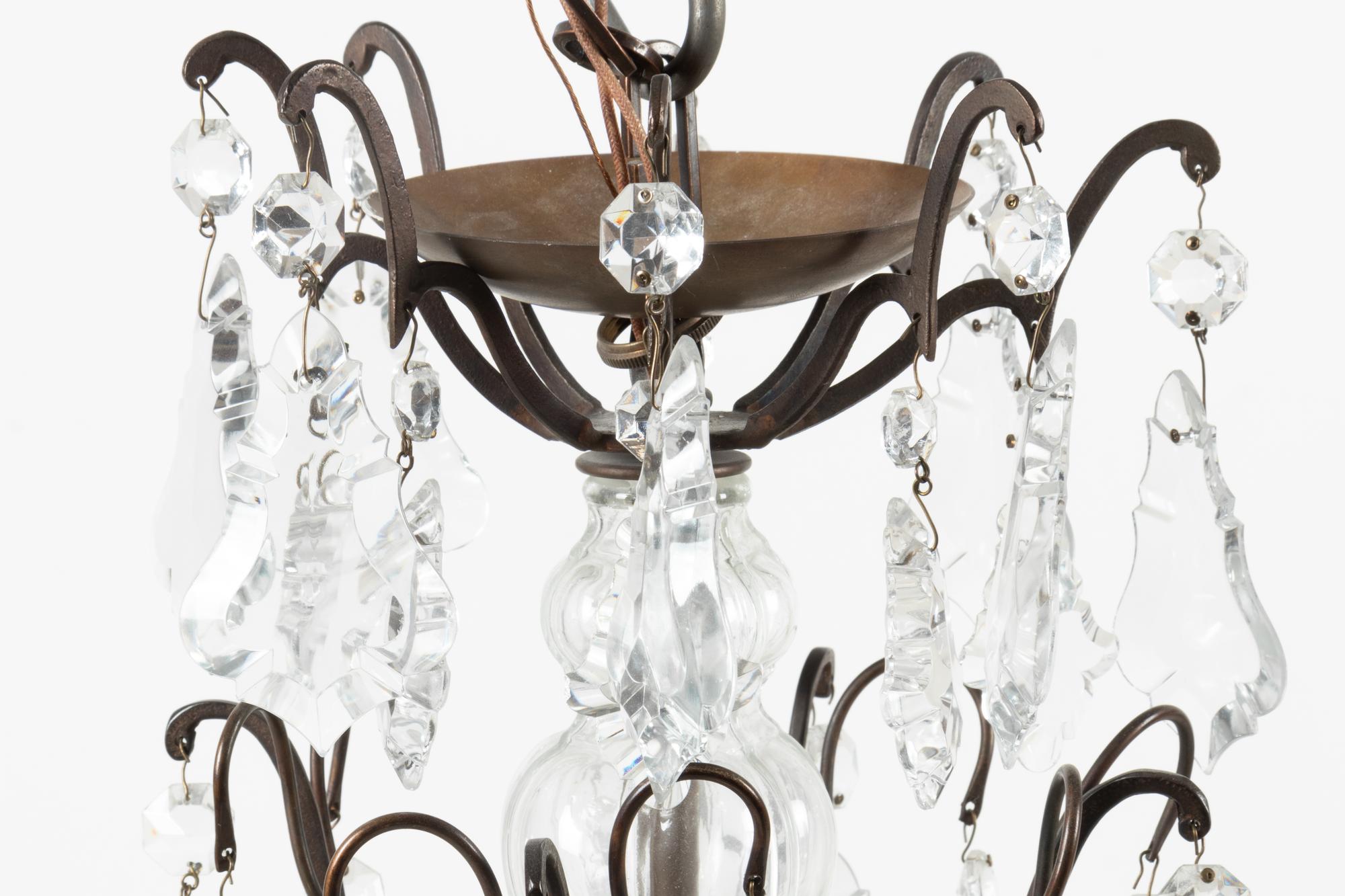 A French Patinated Metal and Cut Glass Eight-Light Chandelier