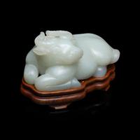 A Chinese Pale Celadon Jade Figure of a Recumbent Buffalo, Qing Dynasty 清 青玉臥牛