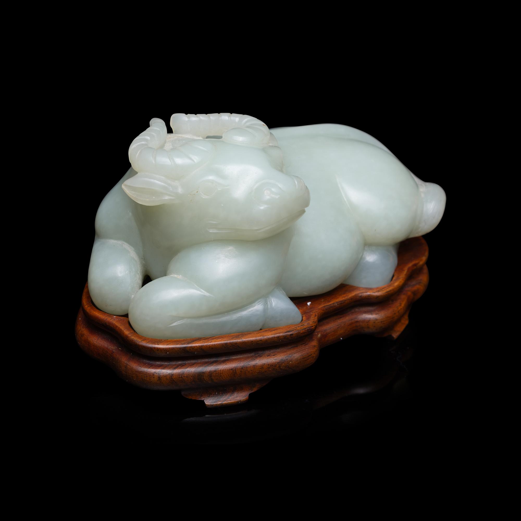 A Chinese Pale Celadon Jade Figure of a Recumbent Buffalo, Qing Dynasty 清 青玉臥牛