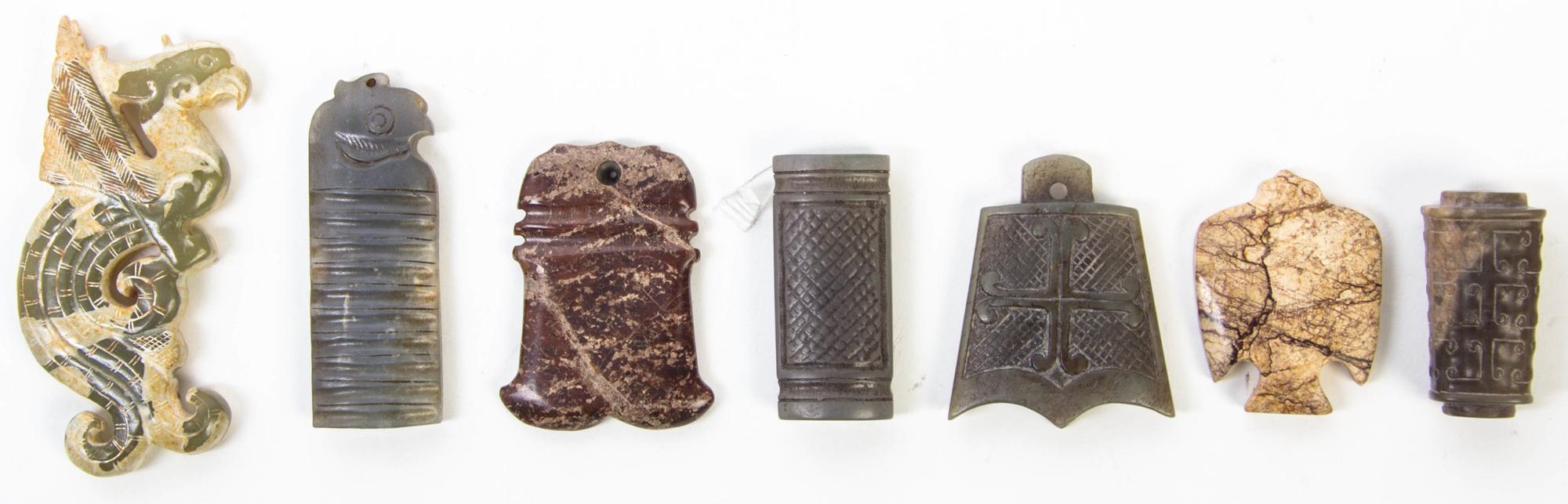 A Group of Seven Hardstone and Jade Toggles Height of tallest 3 3/4 inches.