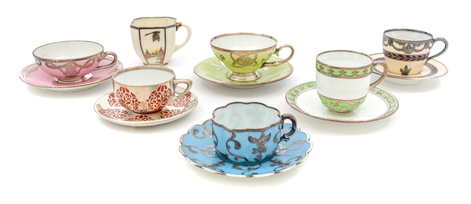 A Group of Silver Overlay Porcelain Teacups and Saucers Diameter of widest 4 3/4 inches.