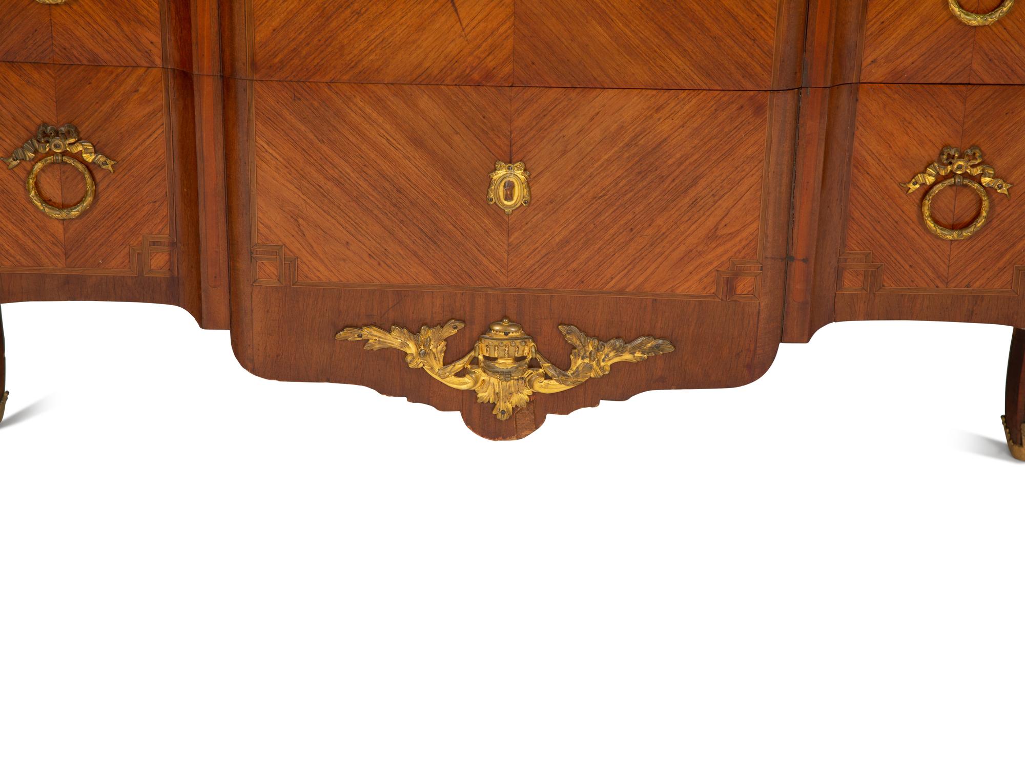 A French Gilt Metal Mounted Mahogany and Kingwood Marquetry Marble-Top Commode