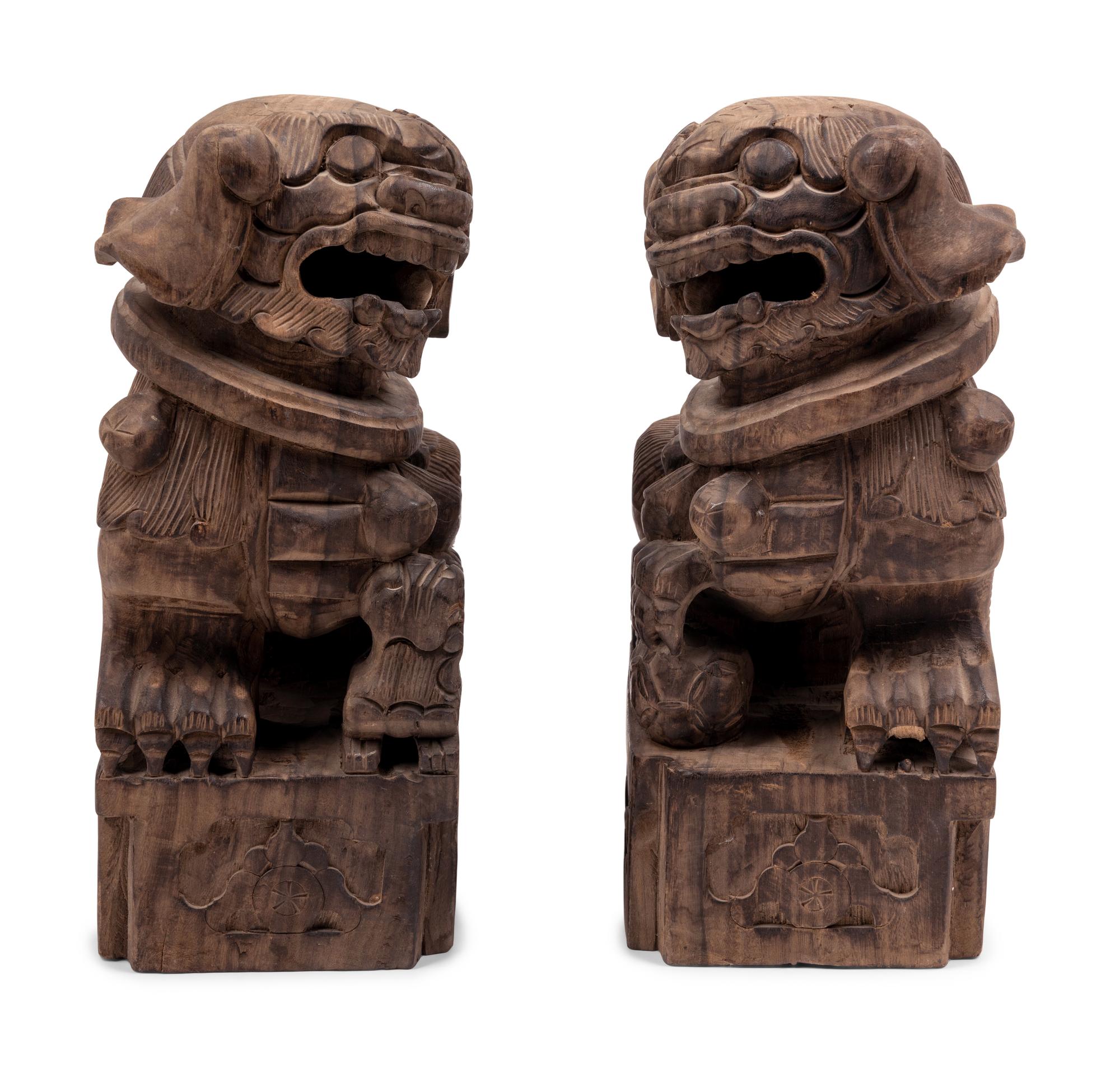A Pair of Carved Wood Buddhistic Lions