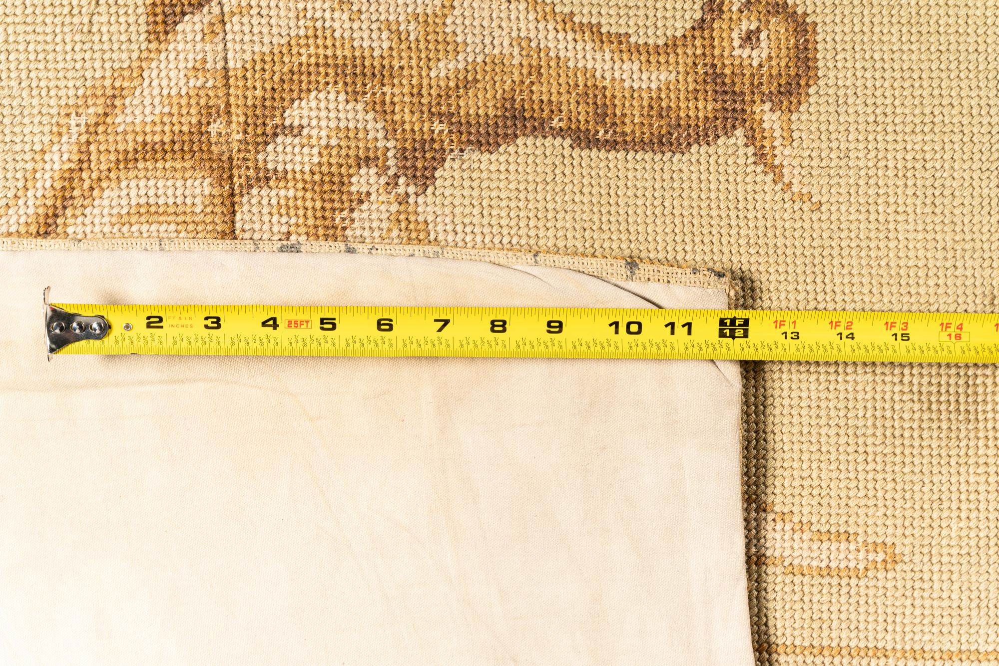 A Large Needlepoint Wool Rug