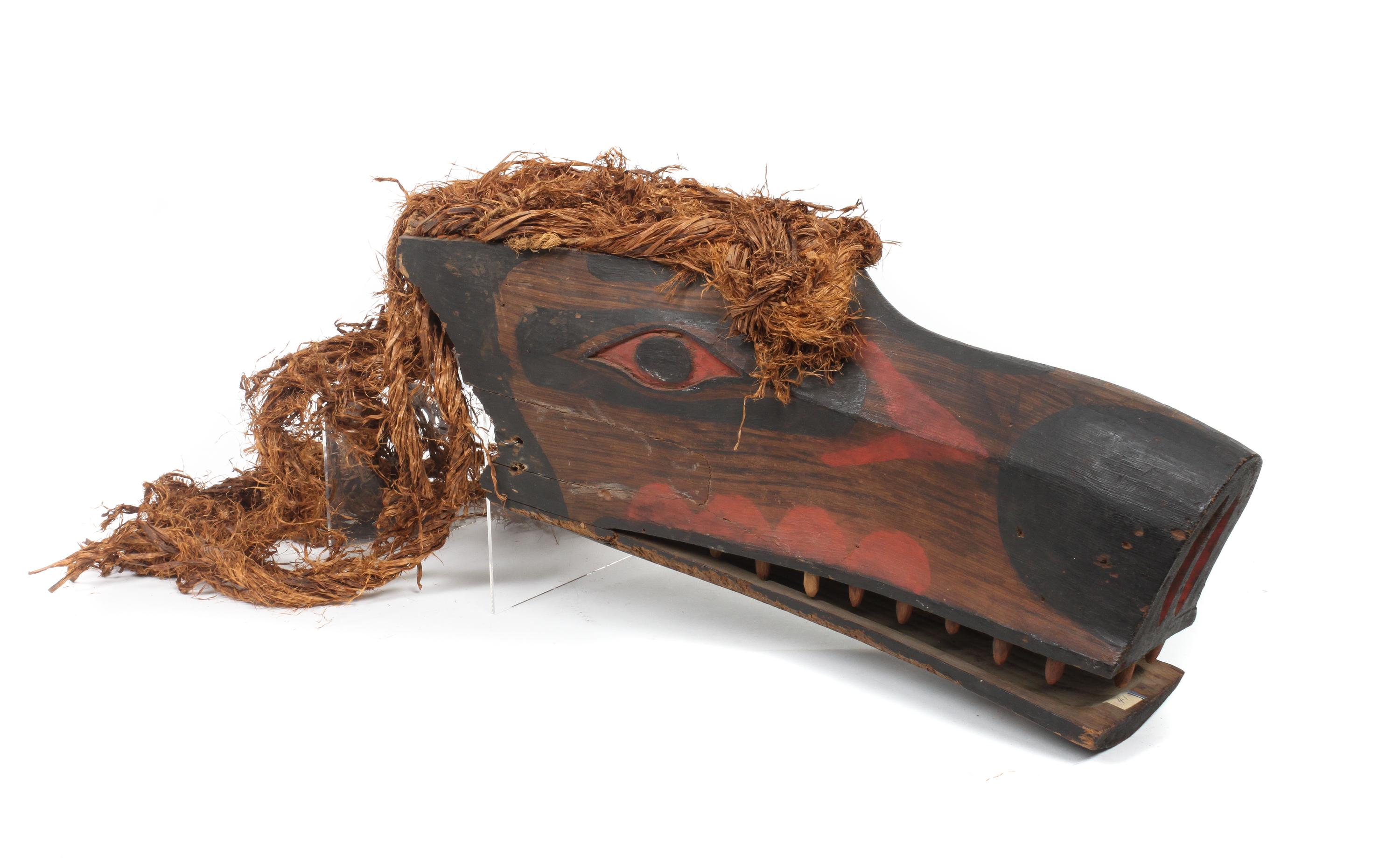 A Kwakwaka'wkw Painted Wood Mask Height 7 1/2 x length 18 x width 5 1/2 inches.