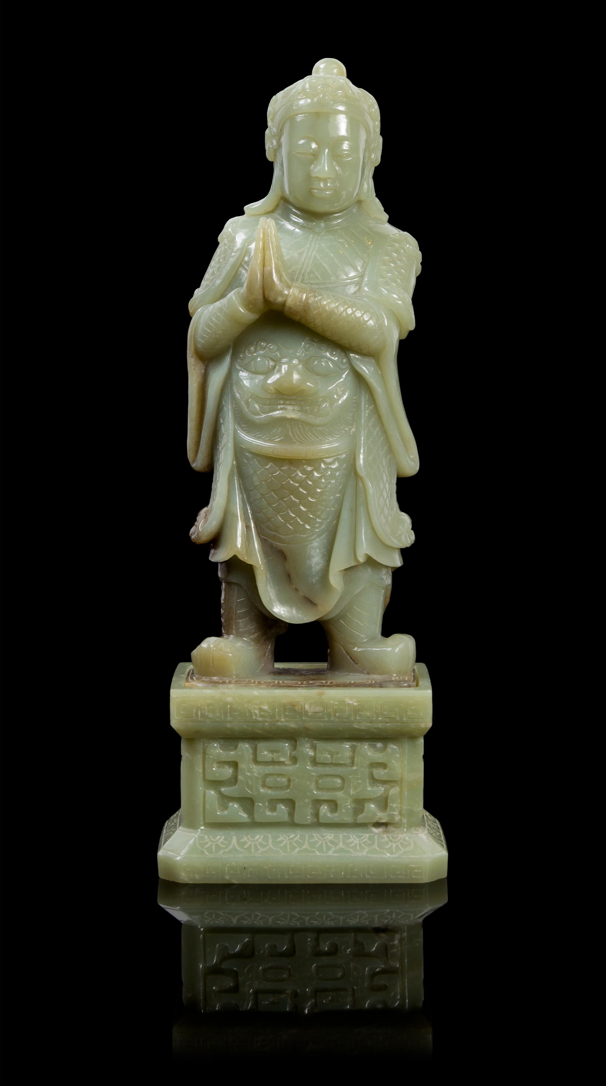 A Chinese Celadon Jade Guardian Figure 20TH CENTURY Height 13 3/8 inches. — 20TH CENTURY