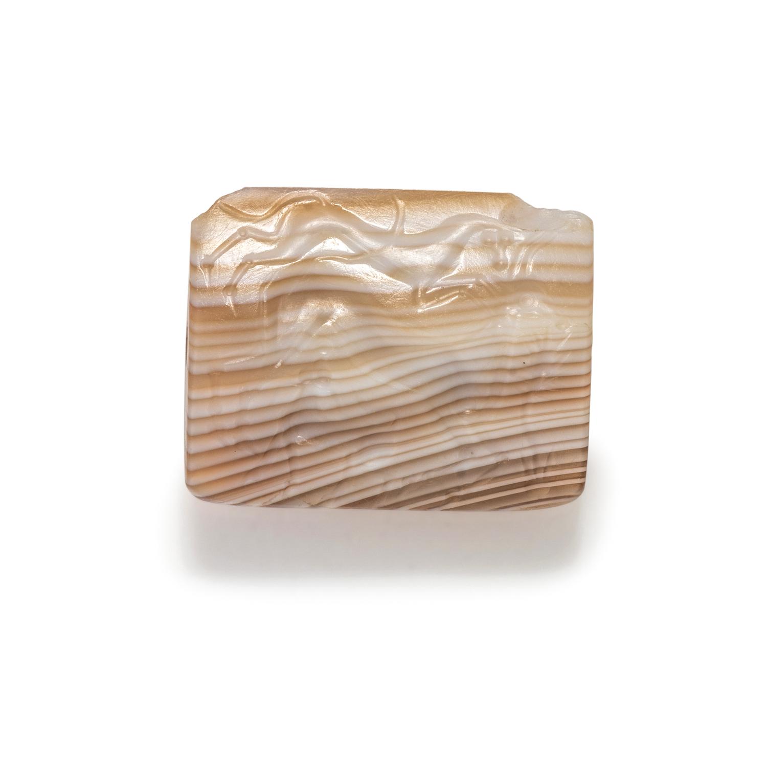 A Minoan Agate Taploid Seal with a Lion Attacking a Cow and Calf