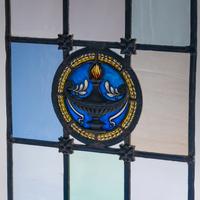 Window with cast metal lamp in circular medallion