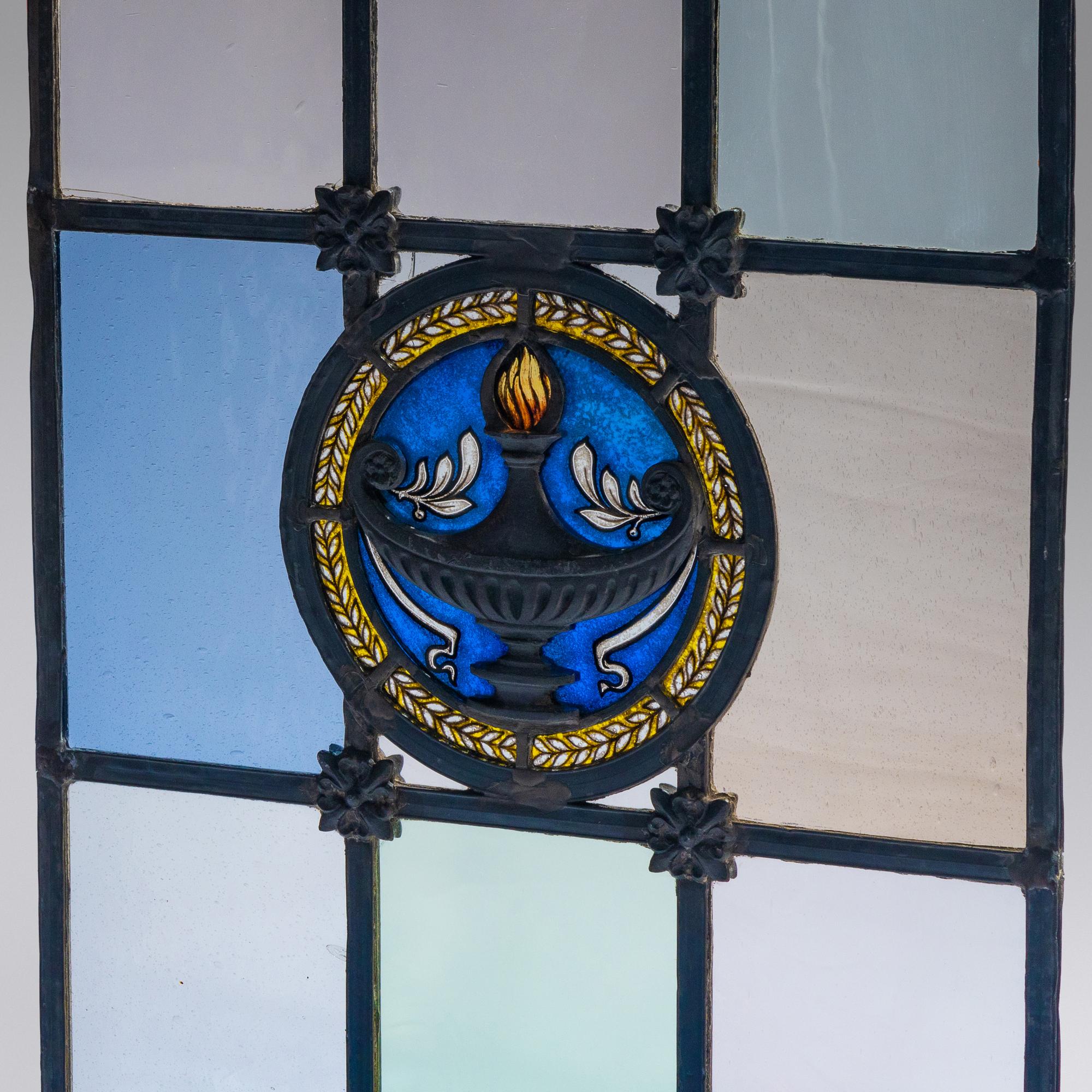 Window with cast metal lamp in circular medallion