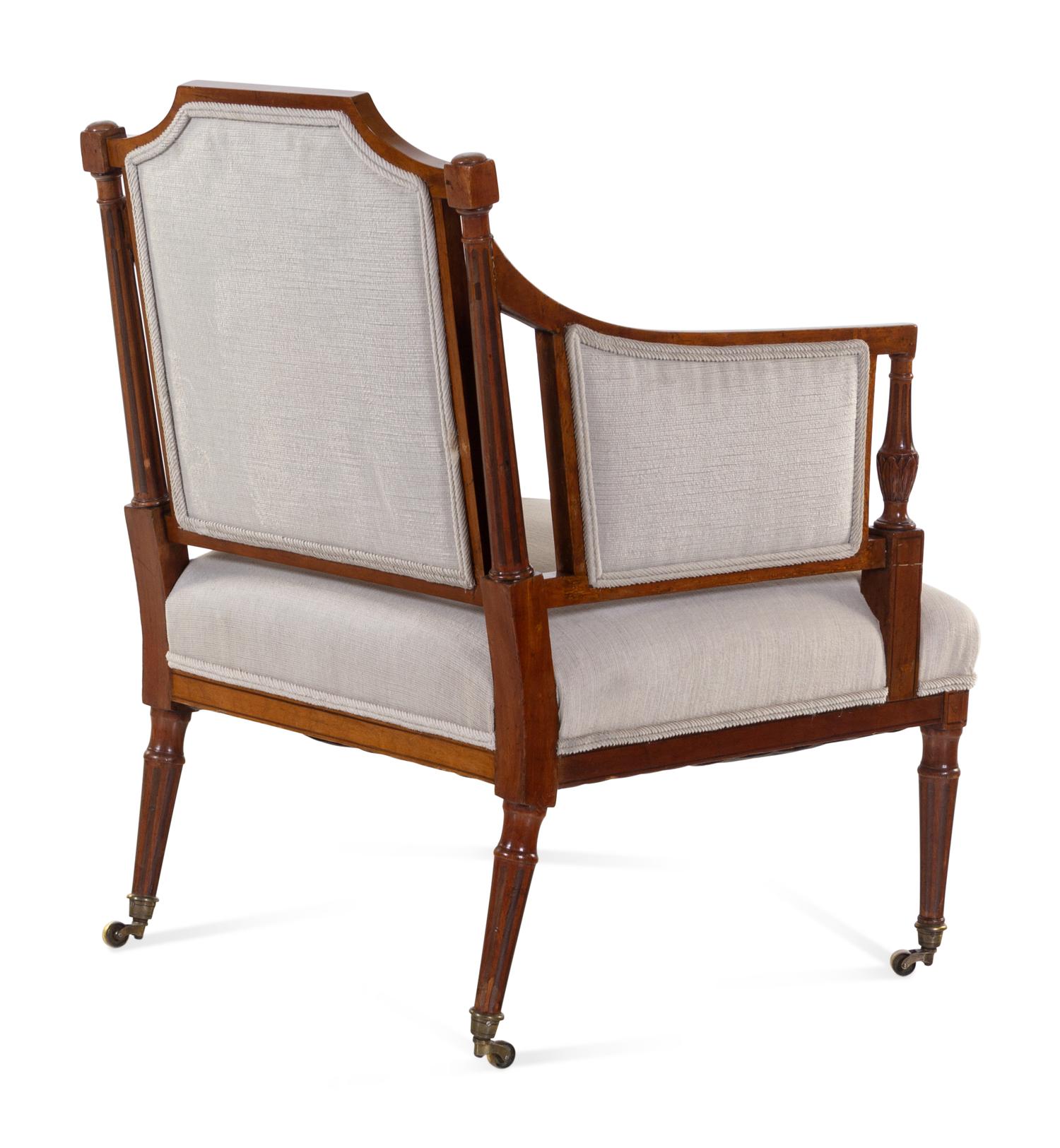 A Regency Style Carved and Inlaid Mahogany Armchair