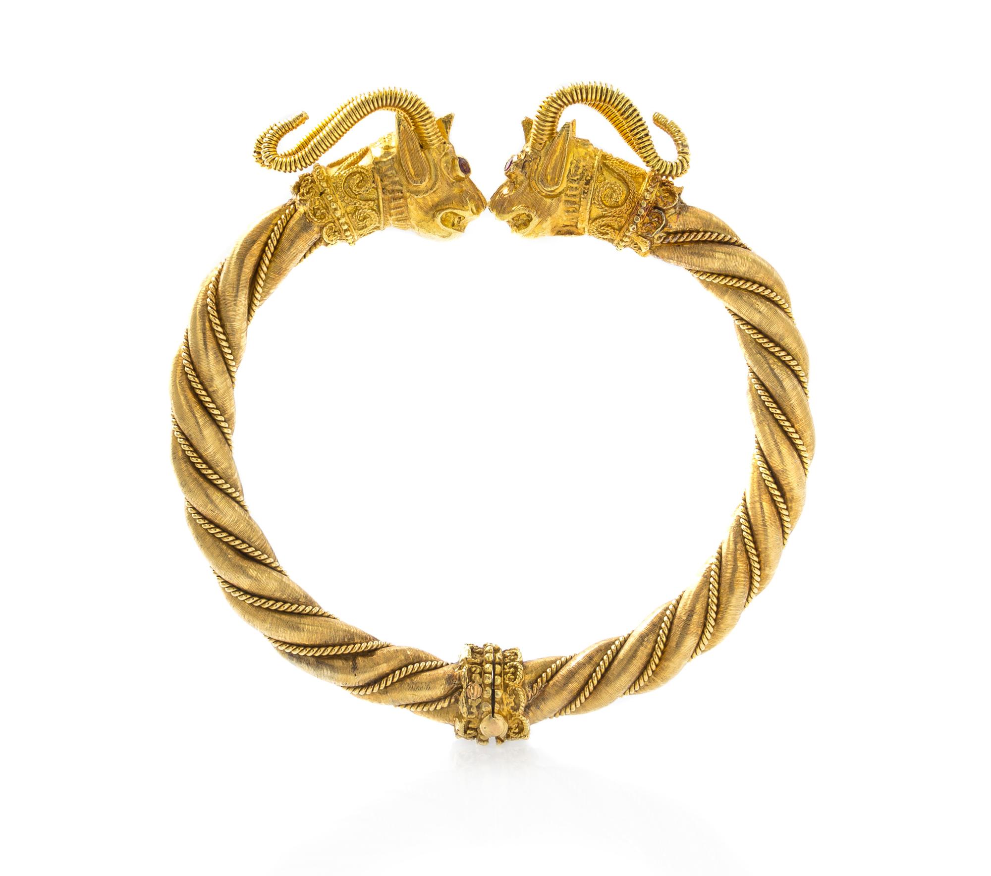 An 18 Karat Yellow Gold and Ruby Rams Head Bangle Bracelet, 39.30 dwts.
