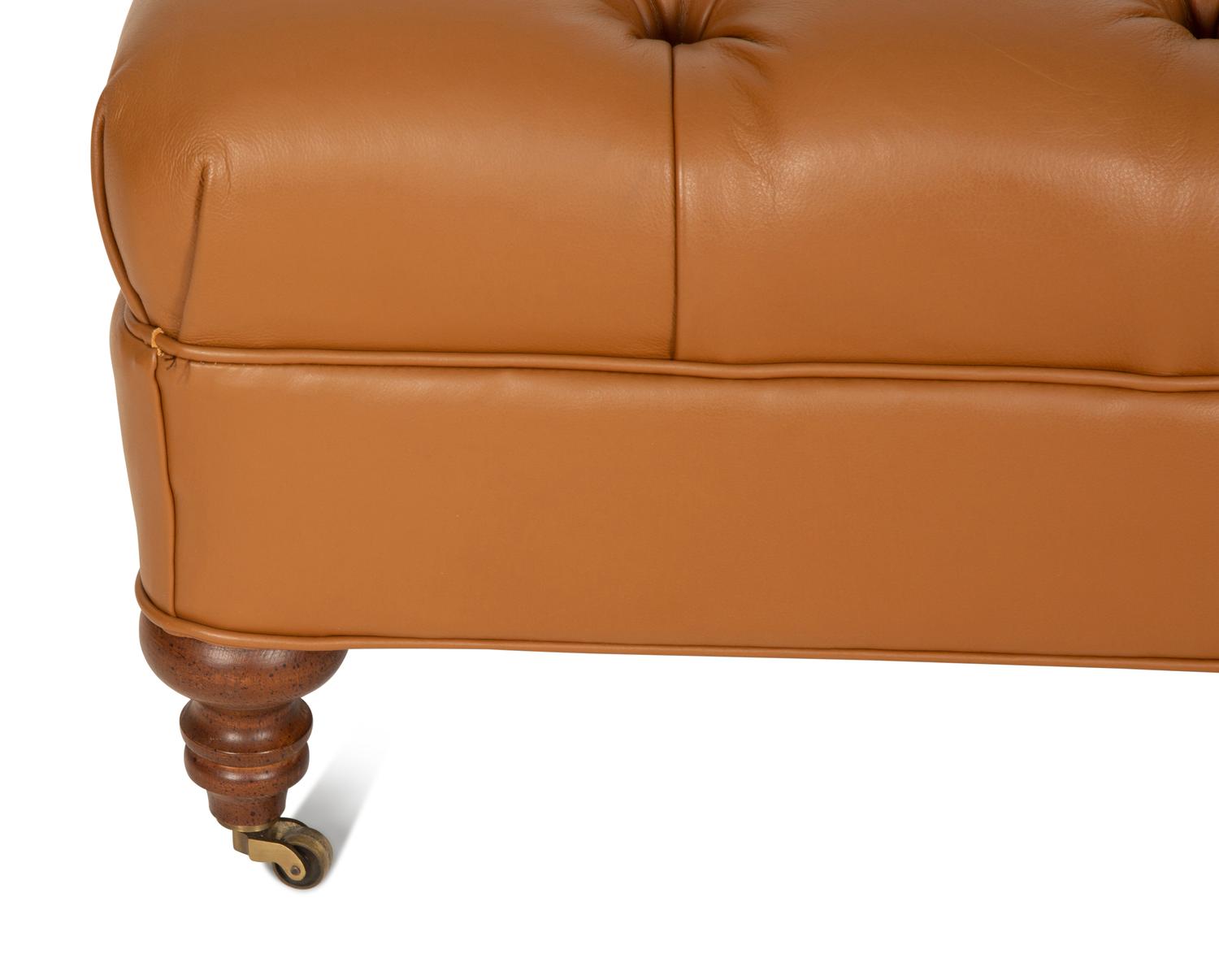 A Regency Style Brown Tufted Leather Upholstered Ottoman