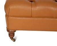 A Regency Style Brown Tufted Leather Upholstered Ottoman