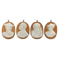 A Set of Four Iron-Mounted Marble Profile Plaques