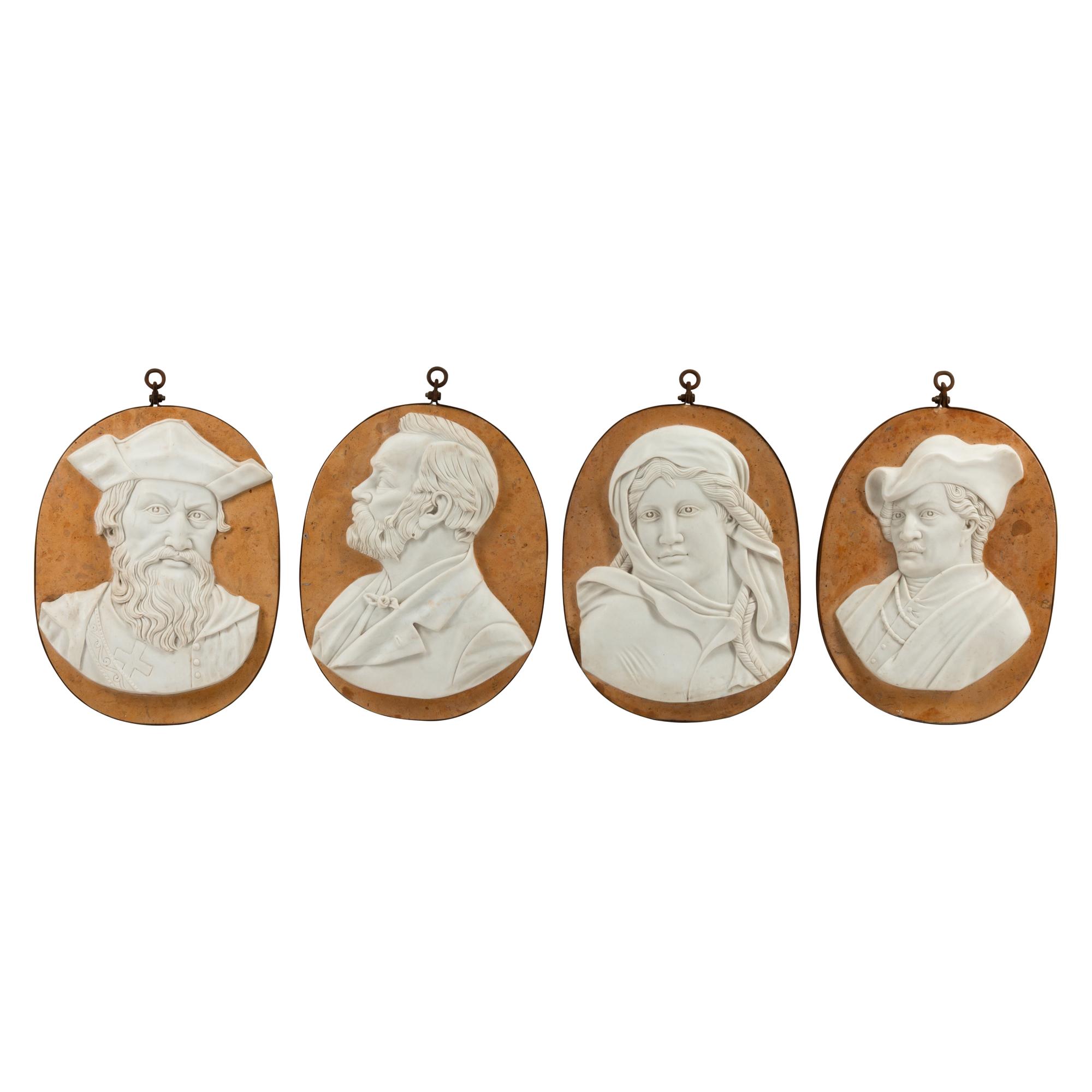 A Set of Four Iron-Mounted Marble Profile Plaques