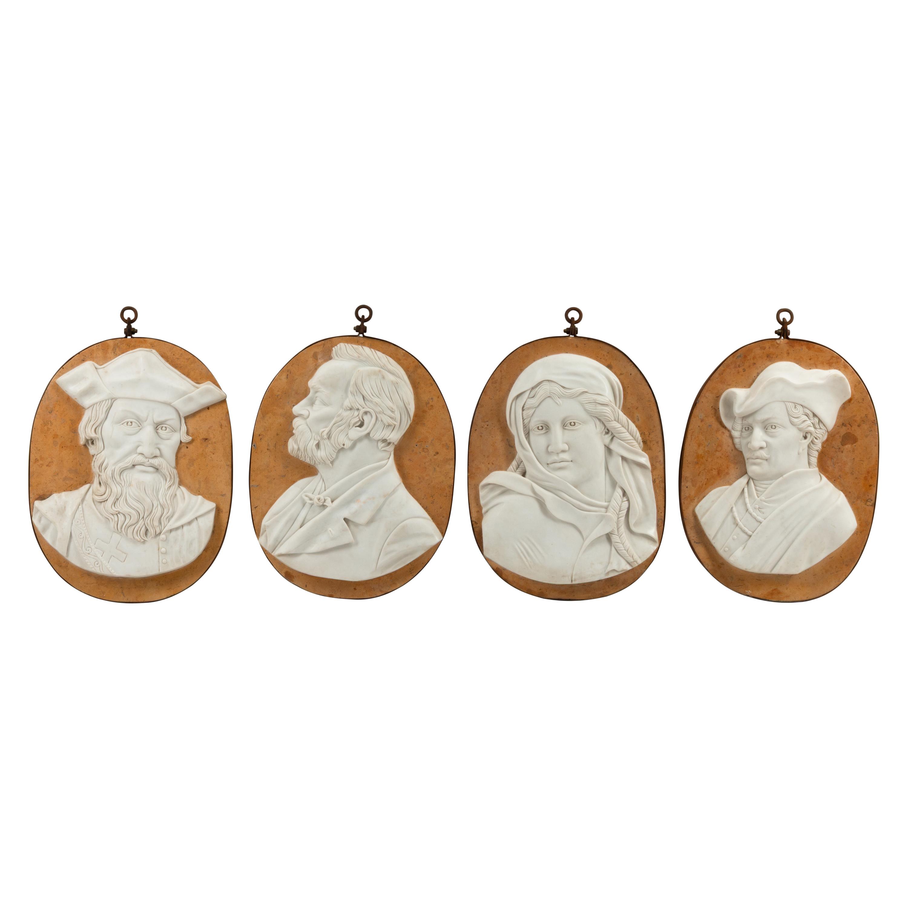 A Set of Four Iron-Mounted Marble Profile Plaques