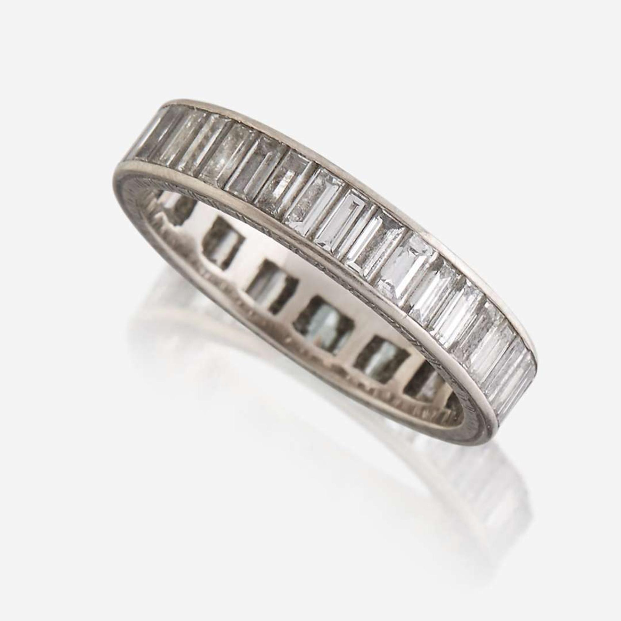 A diamond and fourteen karat white gold eternity band