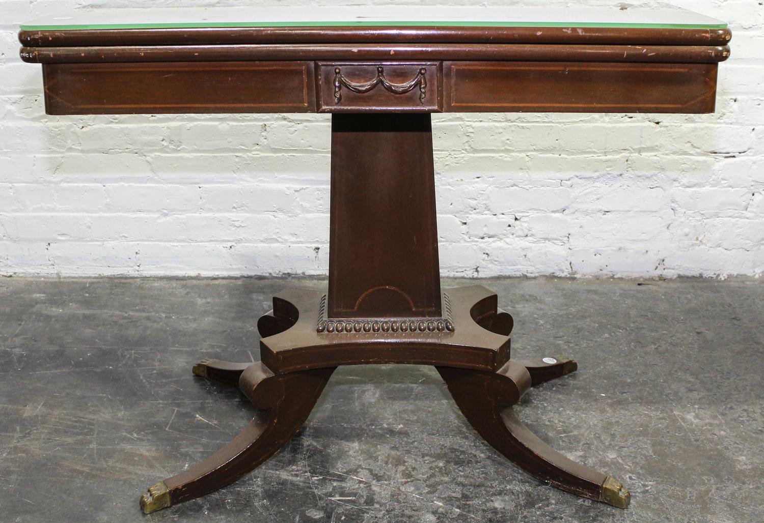 A Duncan Phyfe Style Mahogany Flip-Top Table. Height 27 1/2 x width 35 x depth 18 inches.