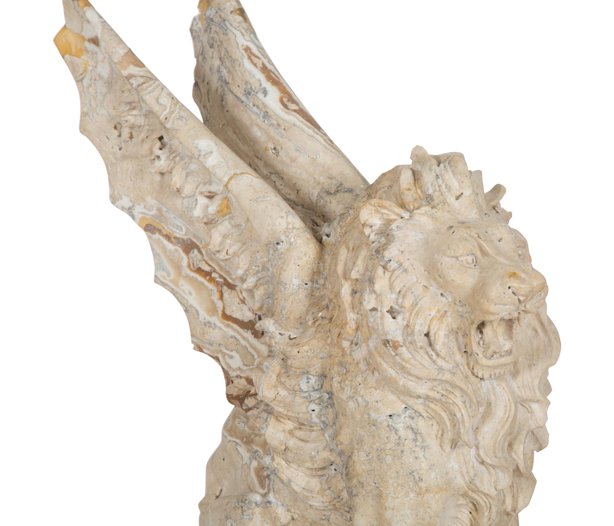 A Carved Marble Winged Seated Lion on Pedestal Base