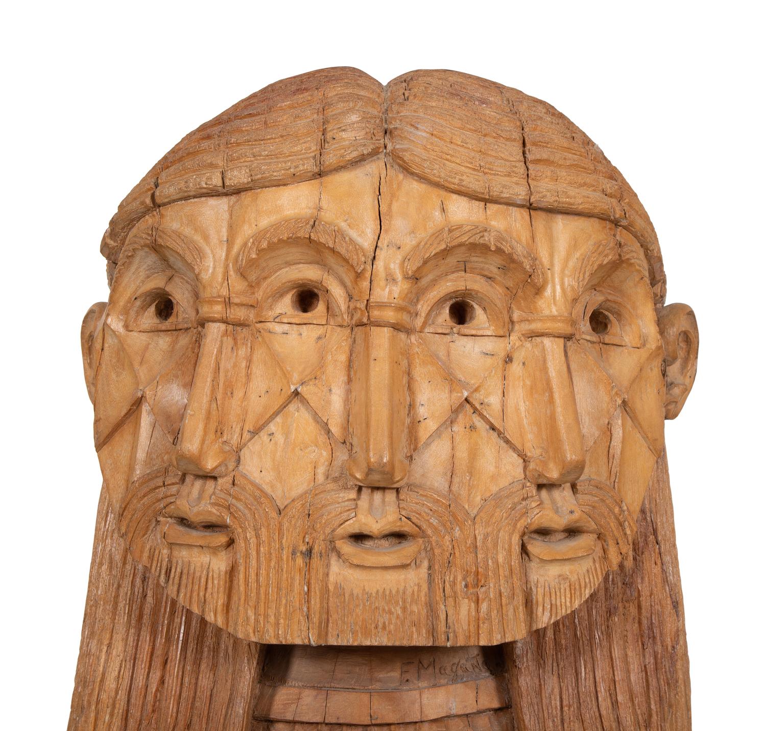 A Carved Wood Sculpture of a Three-Faced Man
