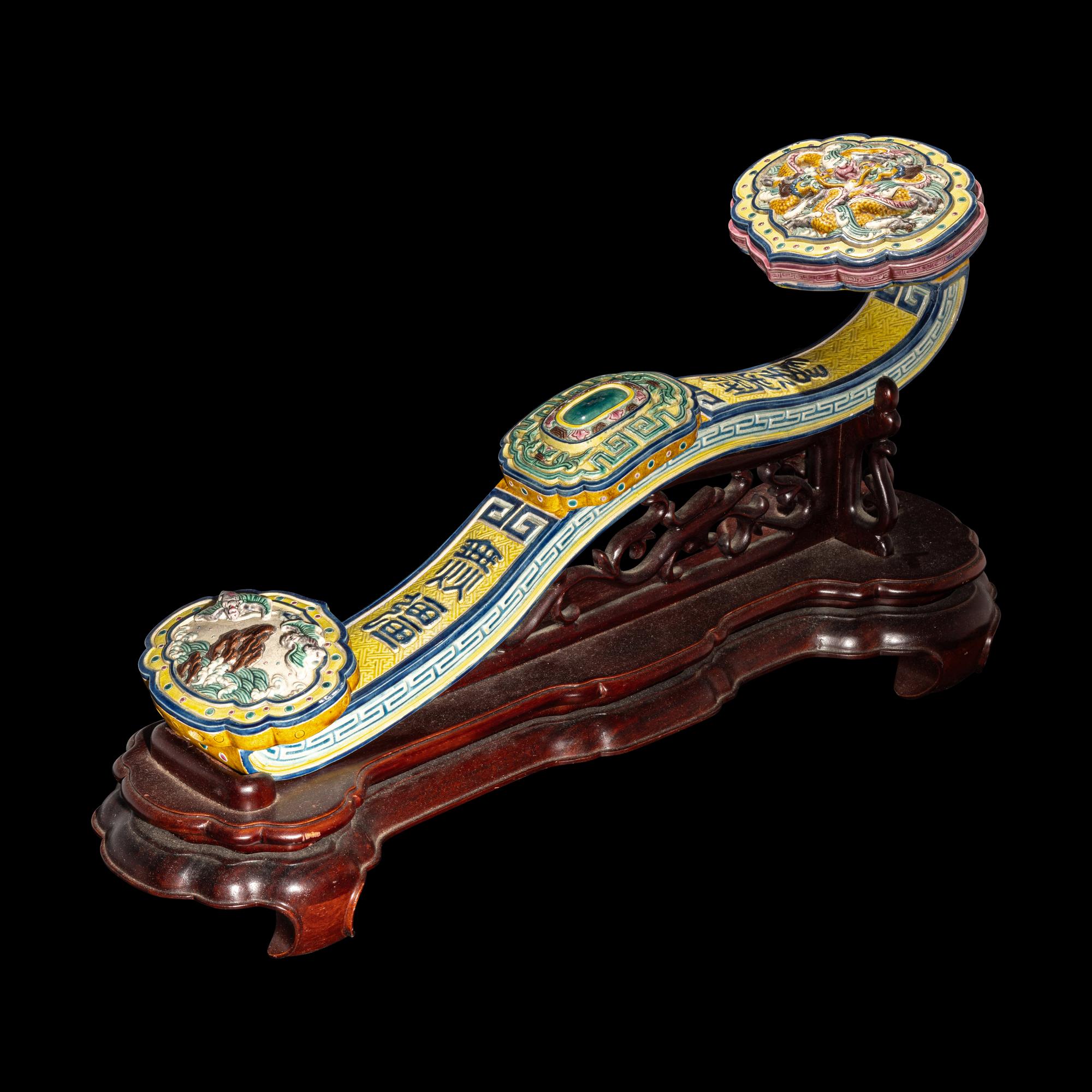 A Chinese Molded Famille Rose Porcelain Ruyi Scepter 粉彩瓷如意配木座