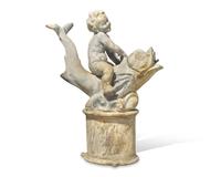 A lead or zinc fountain head in the form of a putto riding a dolphin, 19th / 20th century